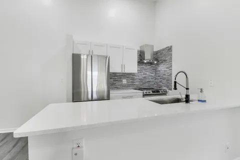 a kitchen with a sink and a refrigerator