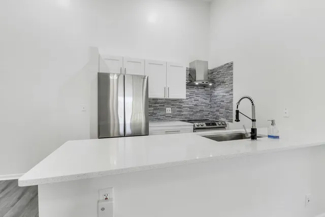 a kitchen with a sink and a refrigerator