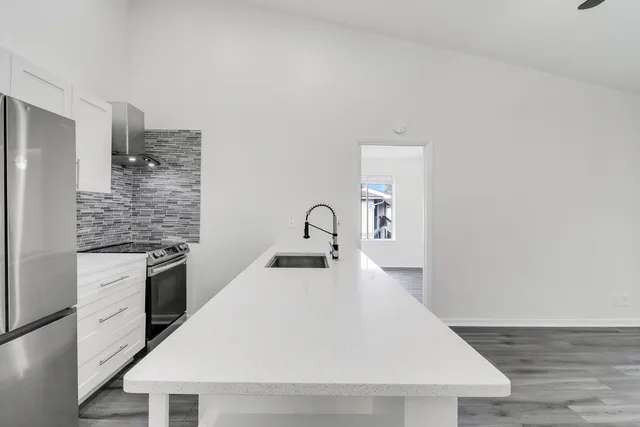 a close view of a sink a faucet and a stove