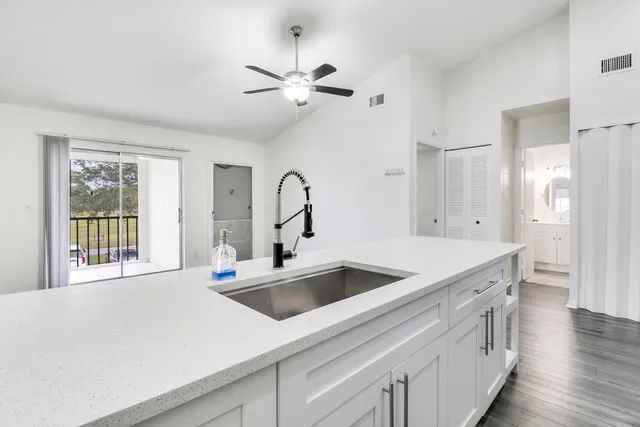 a kitchen with a sink and a refrigerator