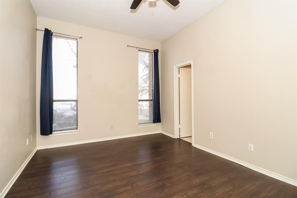 6308 Winton Street Dallas, TX 75214 - Photo 4 of 17 an empty room with wooden floor and windows