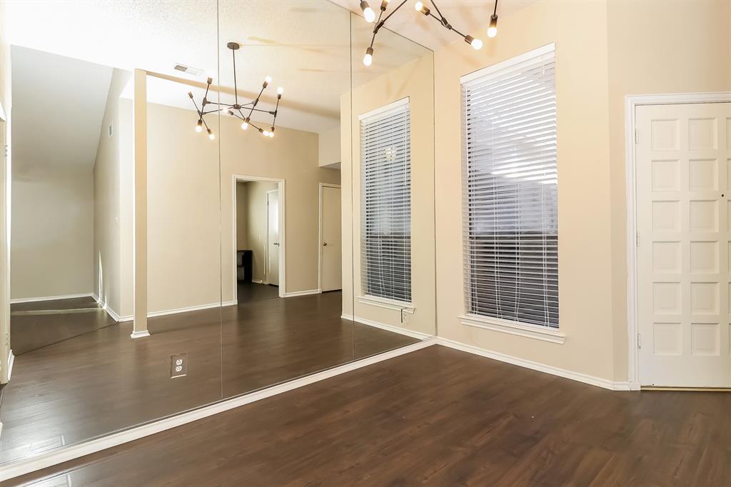 6308 Winton Street Dallas, TX 75214 - Photo 7 of 17 an empty room with wooden floor and windows