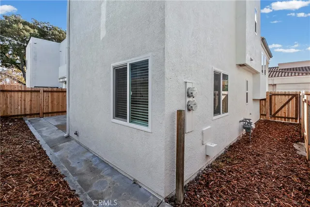 a view of a house with backyard and wooden fence