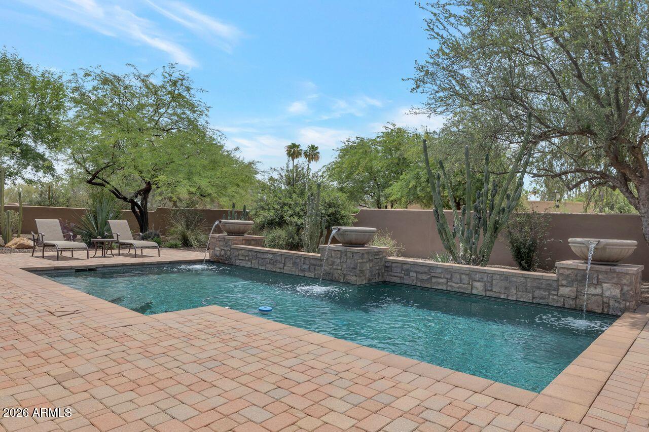 18507 East Picacho Road Rio Verde, AZ 85263 - Photo 28 of 33 a view of a house with swimming pool and a garden