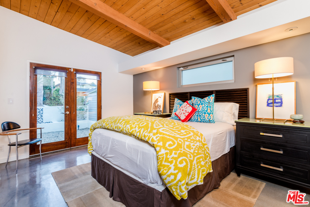 748 Palms Boulevard Venice, CA 90291 - Photo 10 of 17 a bedroom with a bed and wooden floor