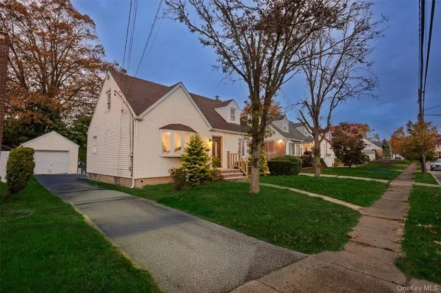 a front view of house with yard and green space