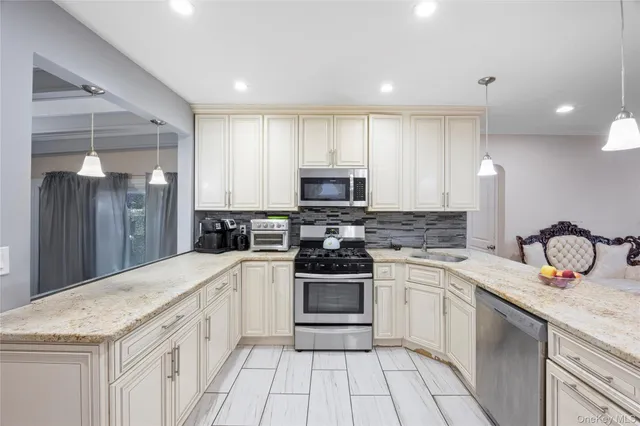 a kitchen with a sink stove and refrigerator