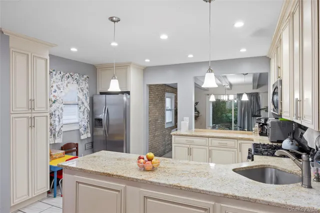 a kitchen with a sink appliances and a counter top space
