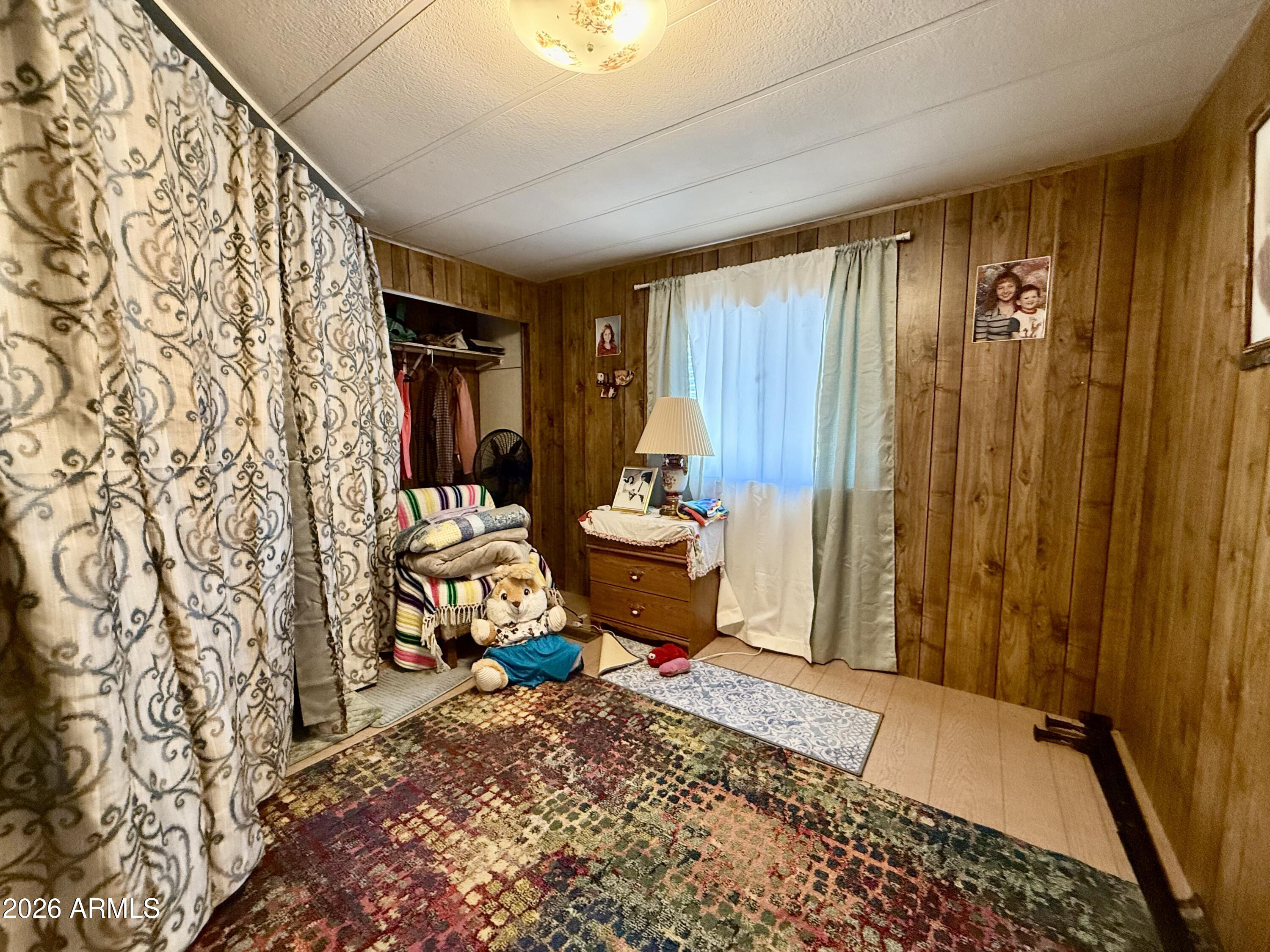 300 Airport Road, Unit 34 Kearny, AZ 85137 - Photo 10 of 18 a bedroom with a bed and a chair