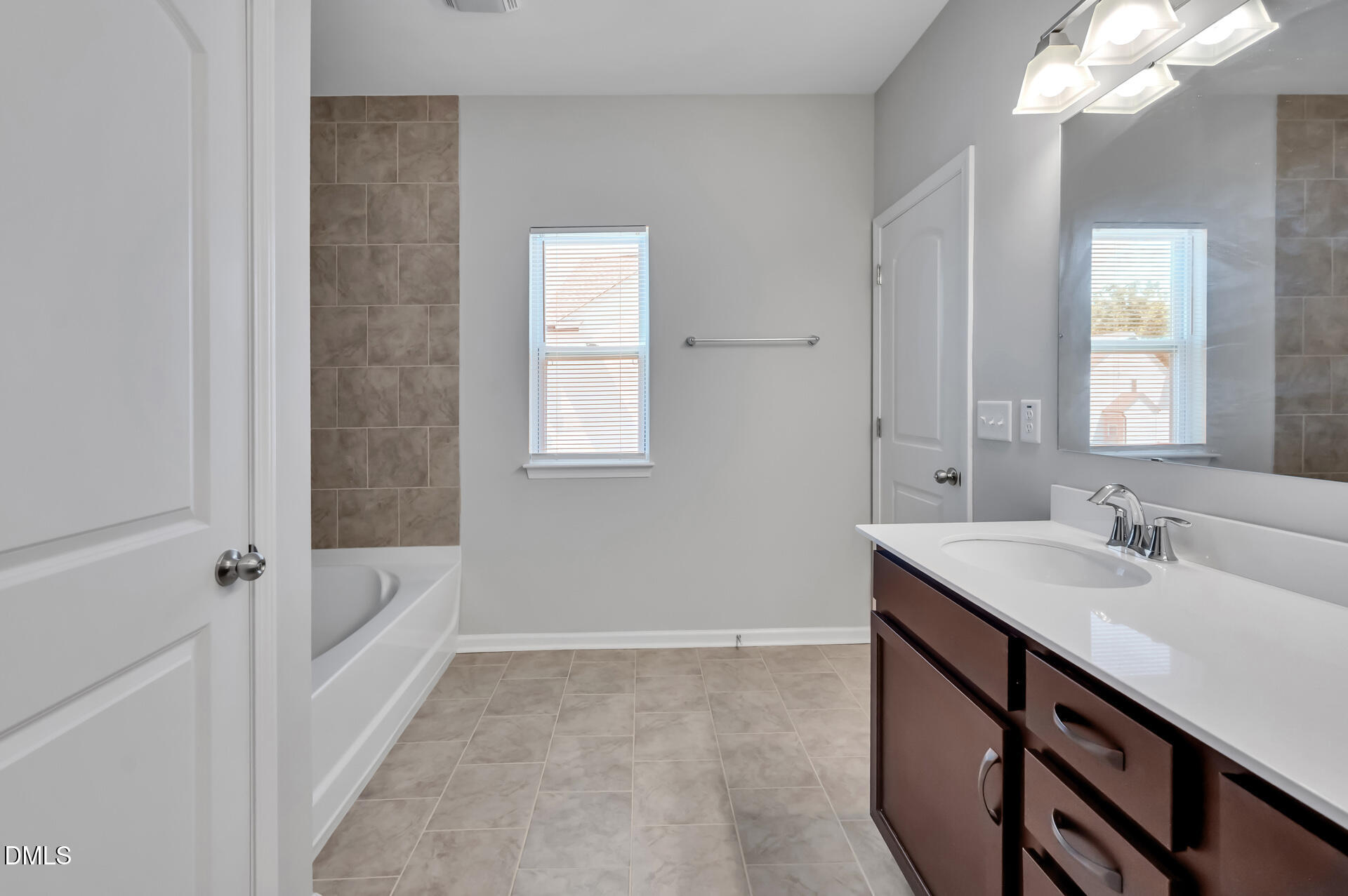5406 Ripplebrook Drive Durham, NC 27712 - Photo 25 of 37 a bathroom with a sink a vanity and a mirror