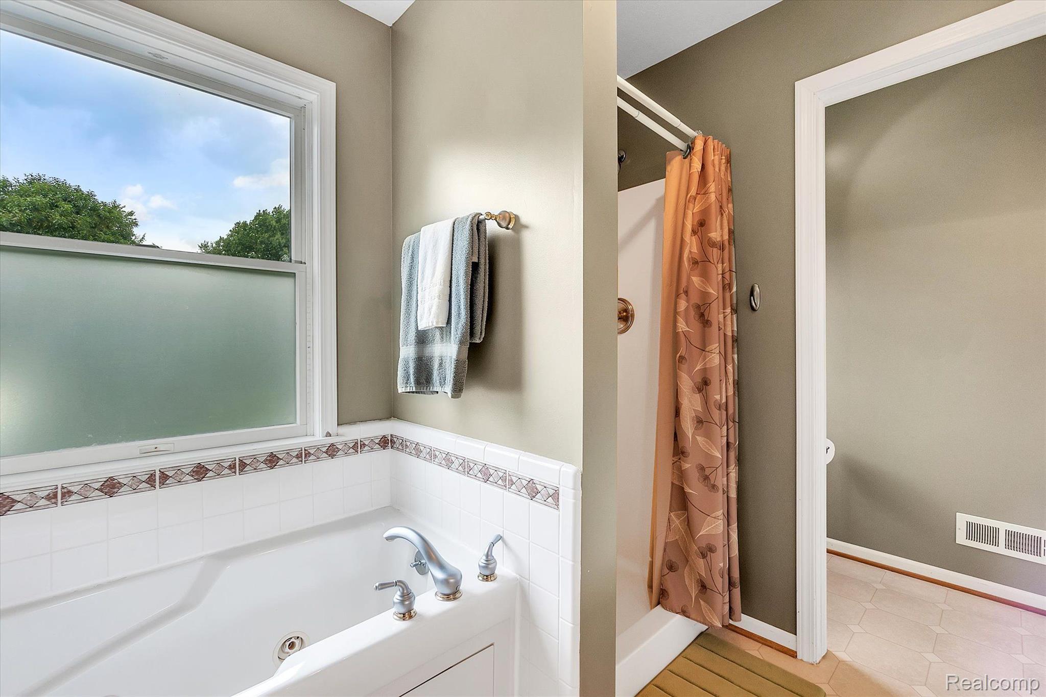9236 West Lamoreaux Road Fowlerville, MI 48836 - Photo 21 of 40 Shower and Tub in Primary w/ separate toilet room