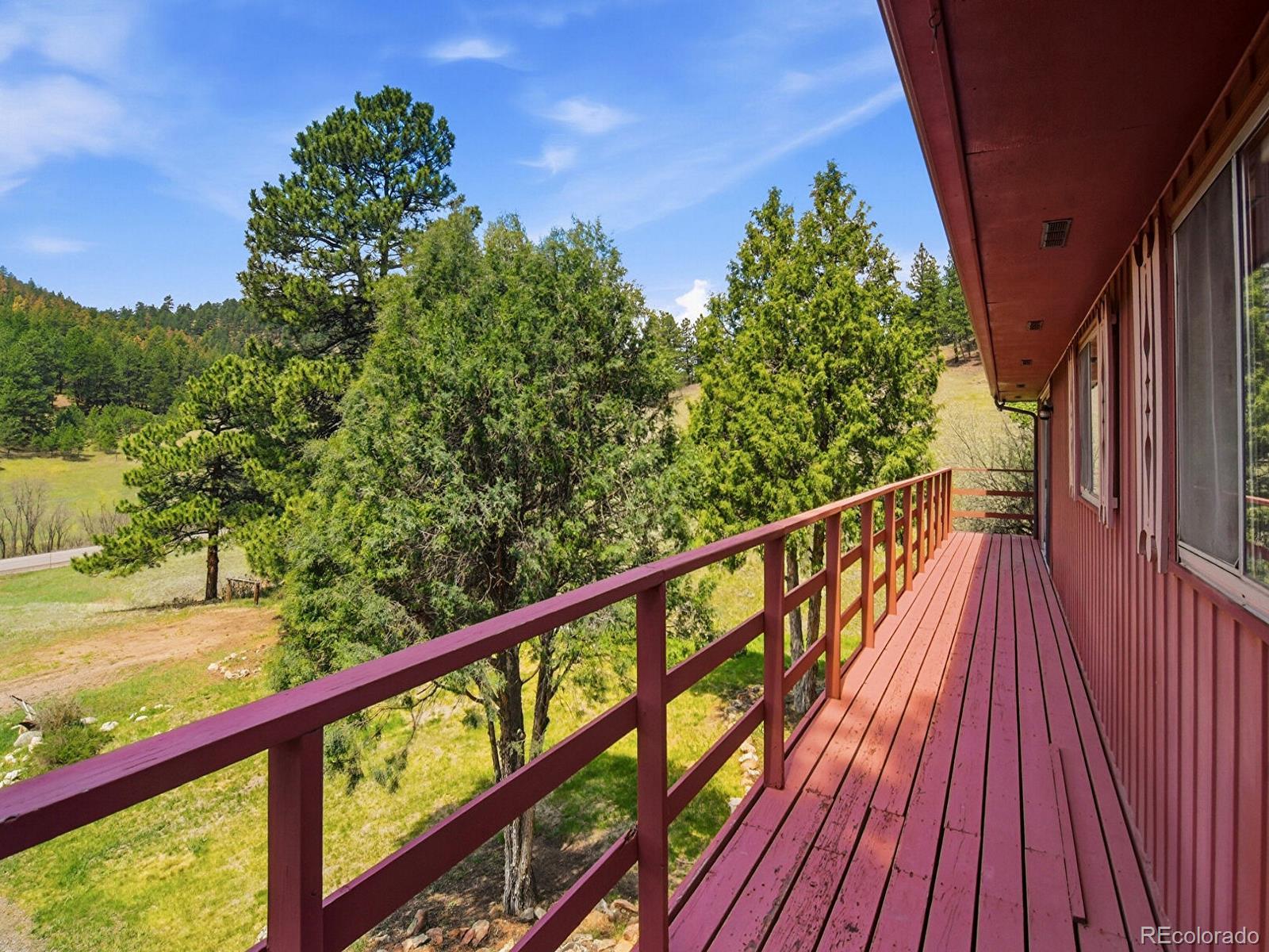 2830 Kerr Gulch Road Evergreen, CO 80439 - Photo 6 of 48 a view of balcony with wooden floor and fence