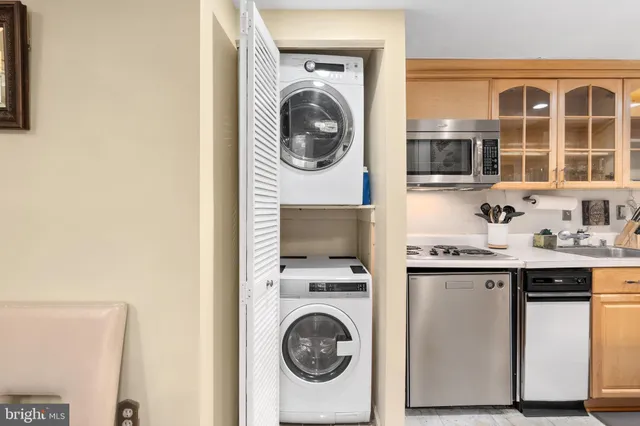a utility room with sink dryer and washer