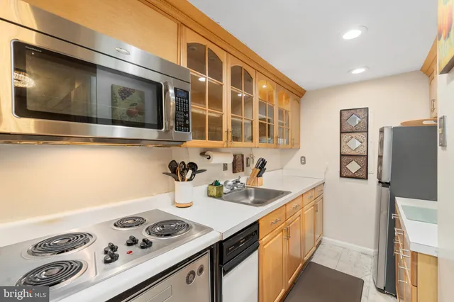 a kitchen with stainless steel appliances a stove a sink and a microwave