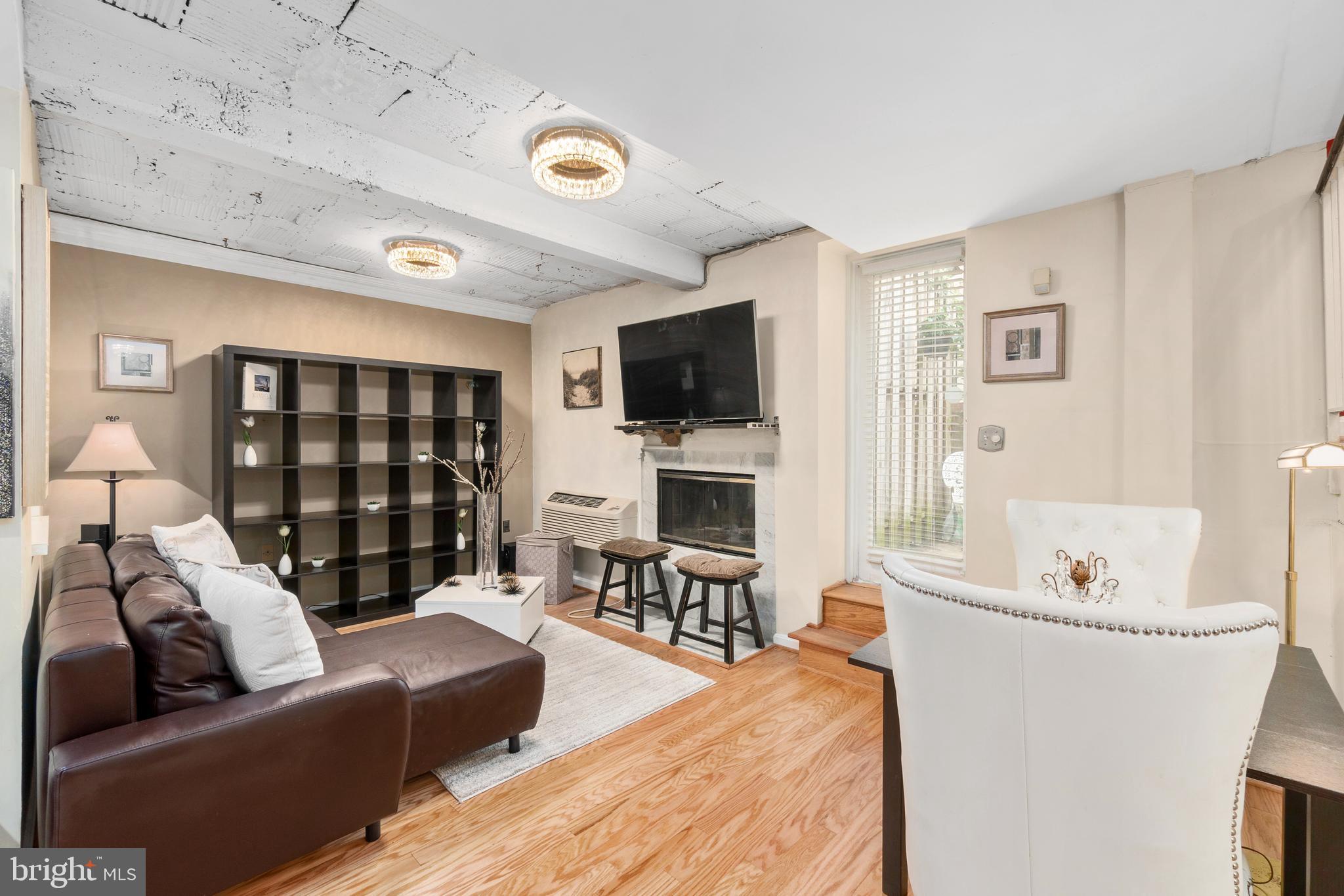 2145 California Street Northwest, Unit 102 Washington, DC 20008 - Photo 14 of 21 a living room with furniture and a flat screen tv