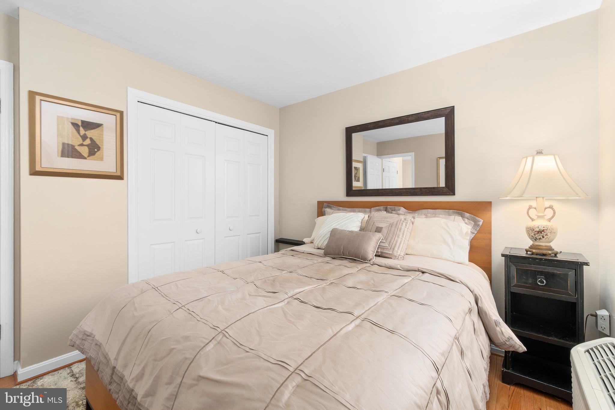 2145 California Street Northwest, Unit 102 Washington, DC 20008 - Photo 5 of 21 a bedroom with a bed and a lamp on dresser
