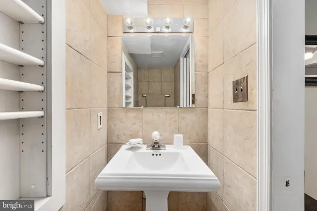 a bathroom with a sink a mirror and a shower