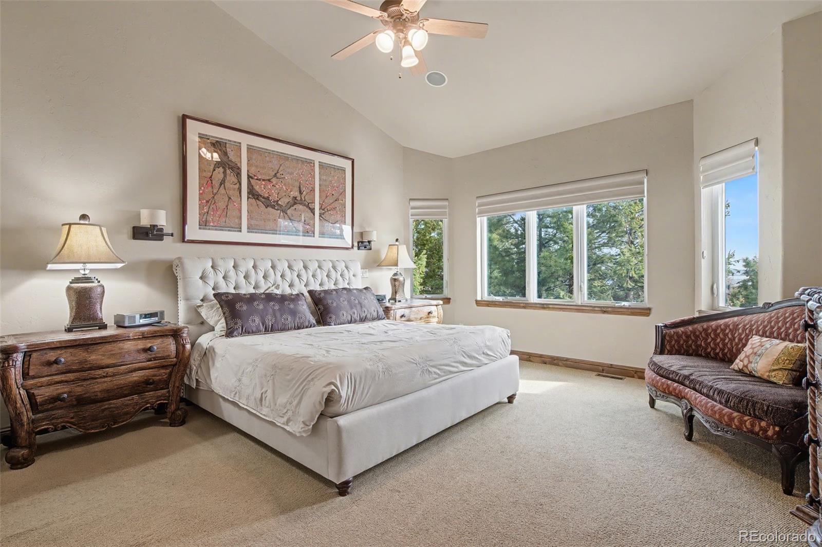 870 Mont Blanc View Colorado Springs, CO 80906 - Photo 15 of 42 a spacious bedroom with a bed and a couch