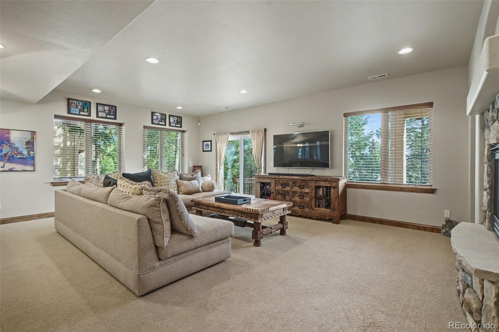 870 Mont Blanc View Colorado Springs, CO 80906 - Photo 24 of 42 a living room with furniture a flat screen tv and a large window