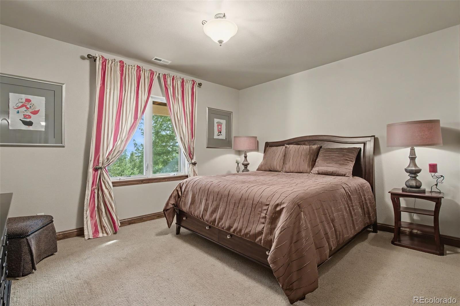 870 Mont Blanc View Colorado Springs, CO 80906 - Photo 28 of 42 a bedroom with a bed and a couch