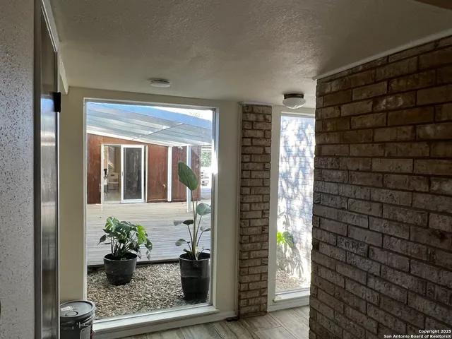 a view of a door and chair front of house
