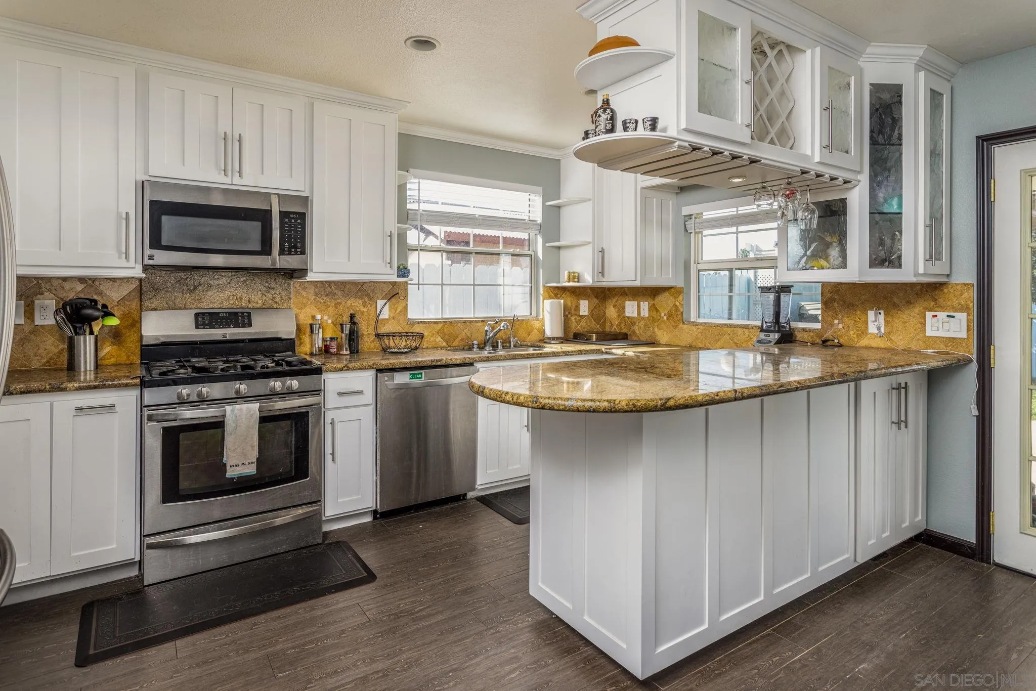 532 Kempton Street Spring Valley, CA 91977 - Photo 8 of 30 a kitchen with stainless steel appliances granite countertop a stove a sink and a microwave