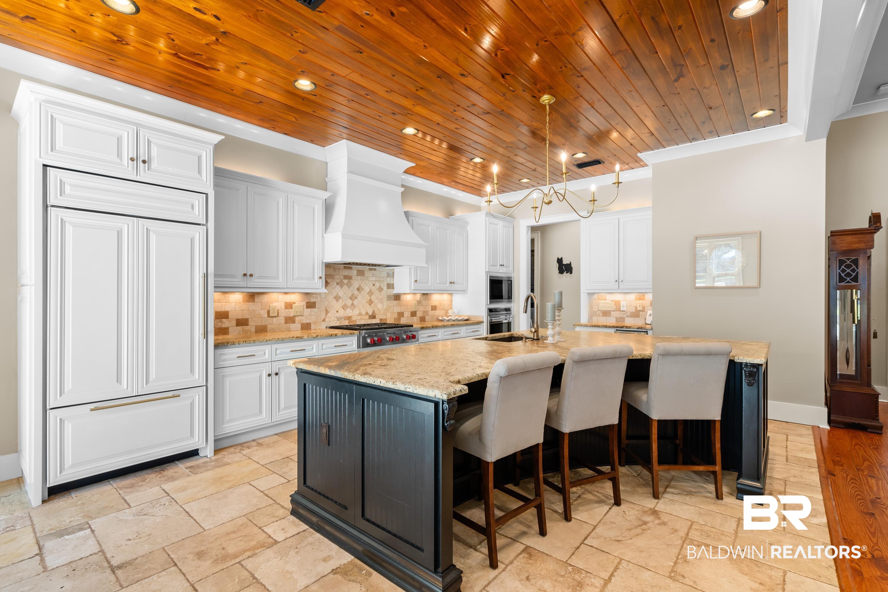 30057 Dolive Ridge Daphne, AL 36527 - Photo 13 of 55 Kitchen with white cabinetry, backsplash, built in appliances, light stone countertops, and a center island with sink