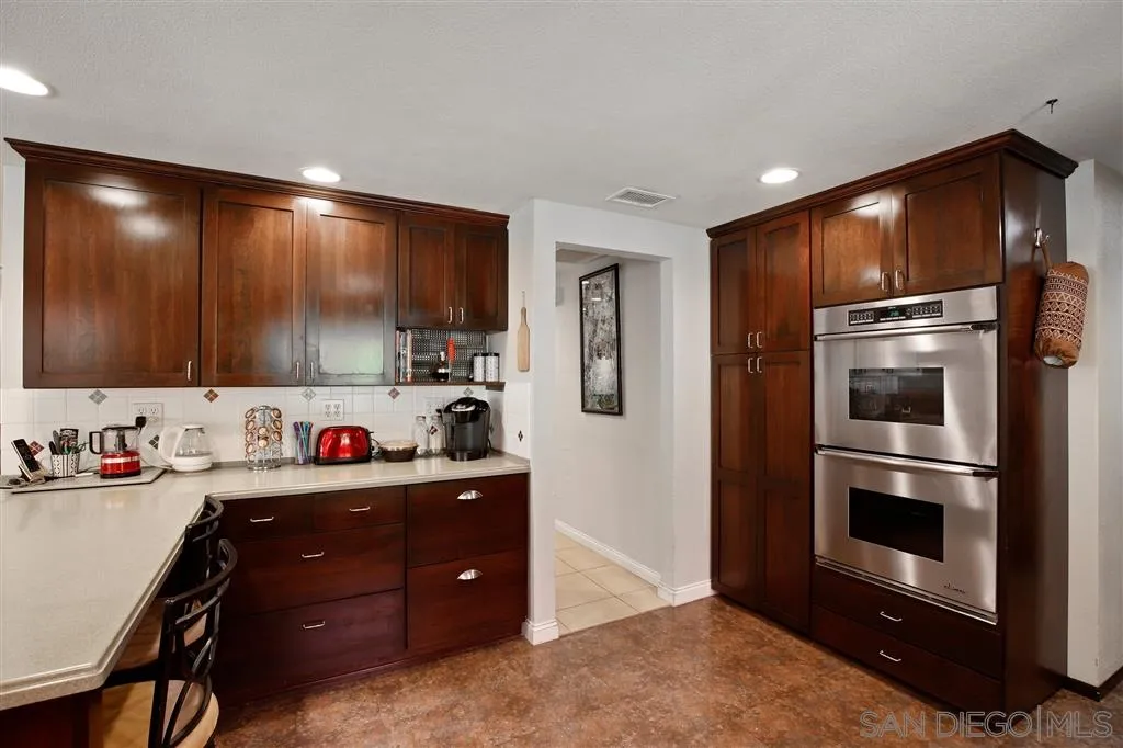 2465 Melru Lane Escondido, CA 92026 - Photo 11 of 25 a kitchen with a refrigerator and cabinets