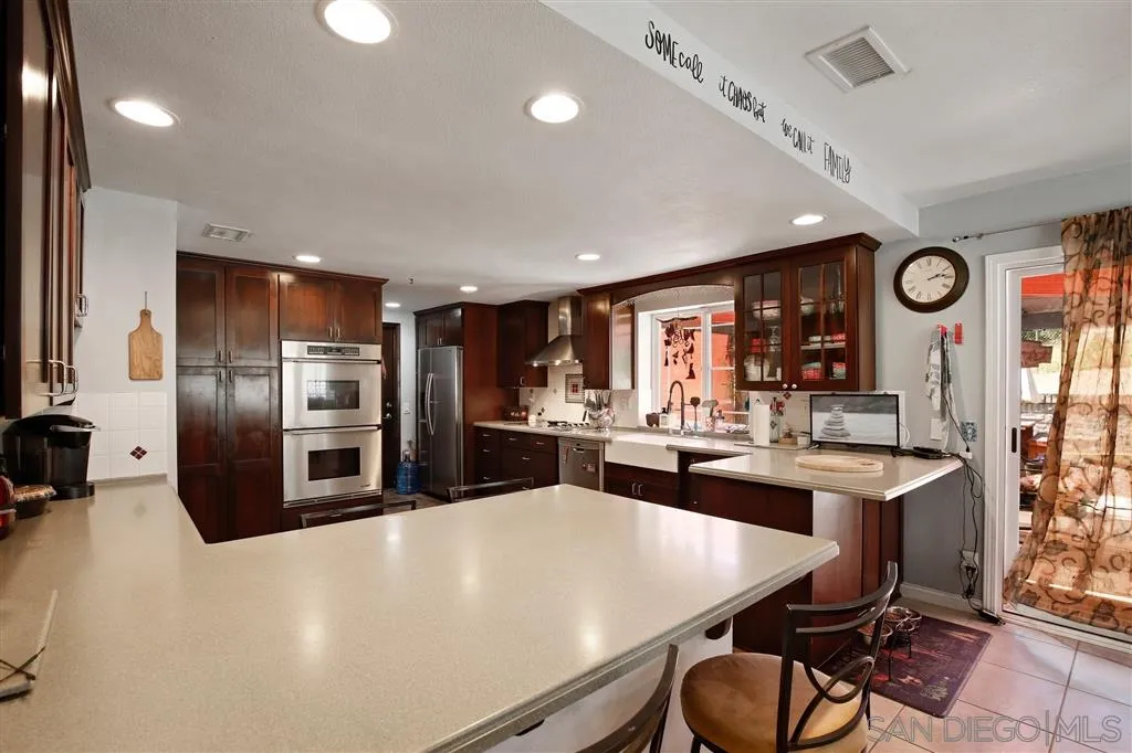 2465 Melru Lane Escondido, CA 92026 - Photo 12 of 25 a kitchen with stainless steel appliances a refrigerator sink and stove