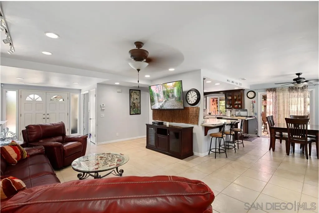 2465 Melru Lane Escondido, CA 92026 - Photo 5 of 25 a living room with furniture a dining table and kitchen view