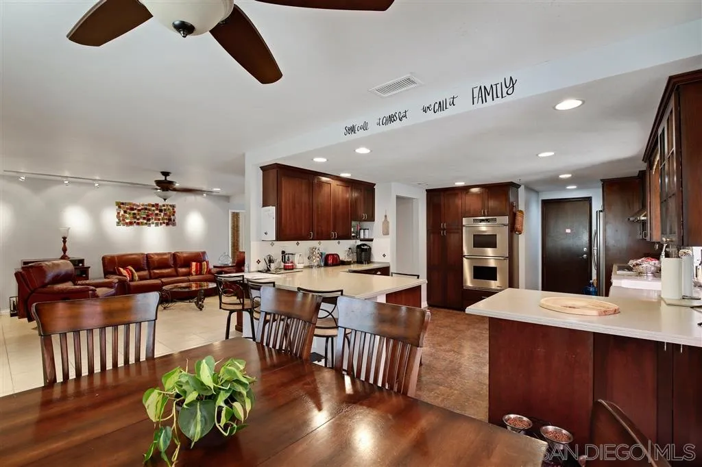2465 Melru Lane Escondido, CA 92026 - Photo 7 of 25 a large kitchen with a table and chairs