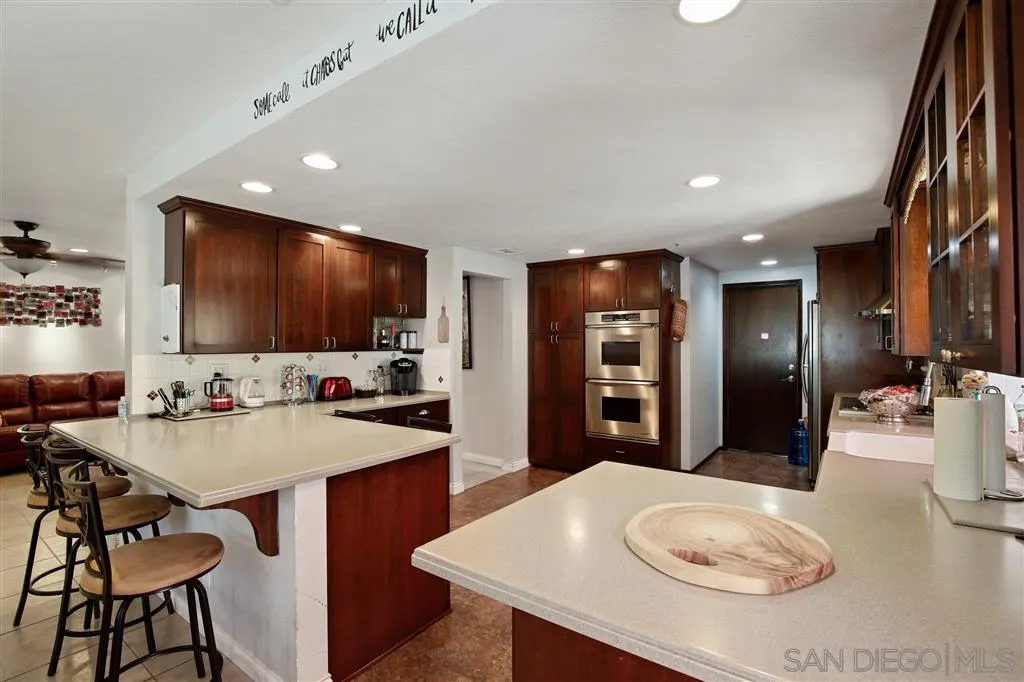 2465 Melru Lane Escondido, CA 92026 - Photo 9 of 25 a kitchen with a dining table and chairs