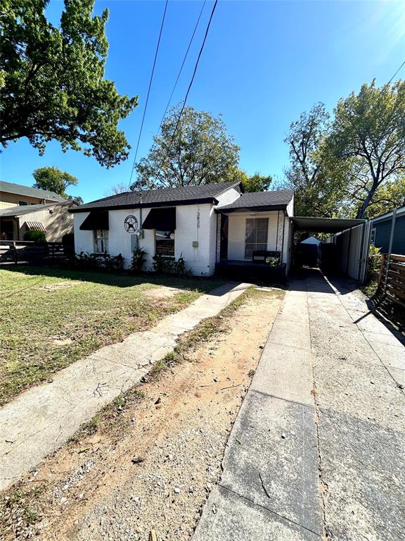 View of front of property featuring a carport, and driveway.