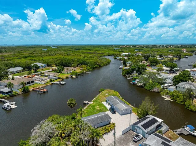 an aerial view of a houses with ocean view