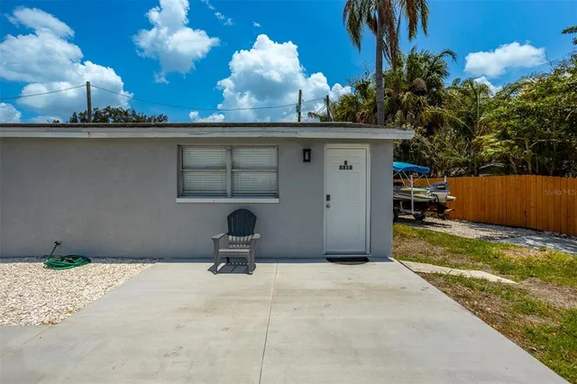 a backyard of a house with table and chairs