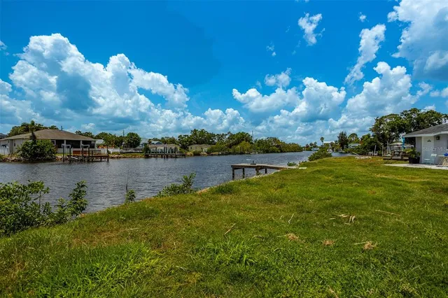 a view of a lake with houses in the back