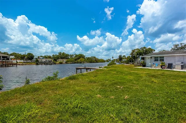 a view of a lake with houses in the background