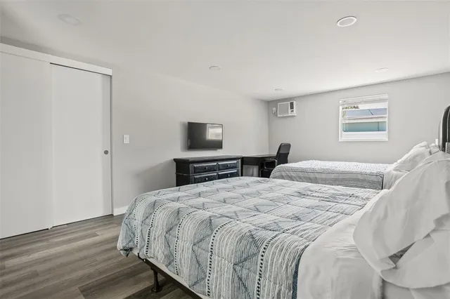 a bedroom with a bed and a tv