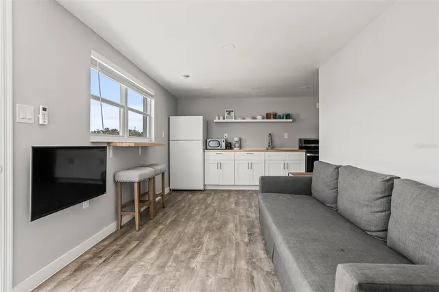 a living room with furniture and kitchen view