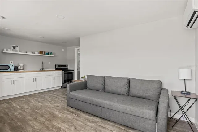 a living room with furniture and a view of bedroom