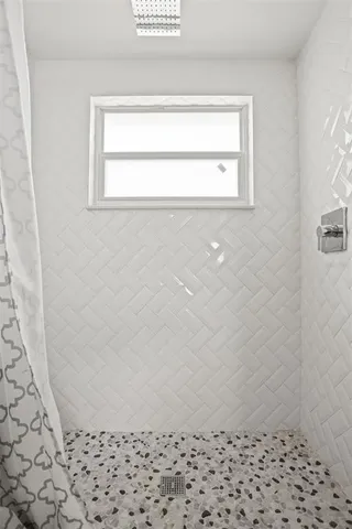 a bedroom with a bed and a lamp with wooden floor