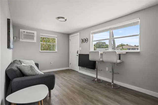 a living room with furniture and white walls