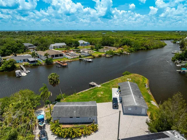 an aerial view of a house with a lake view