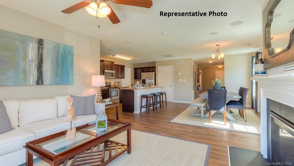 7261 Finnigan Road Charlotte, NC 28215 - Photo 11 of 40 a living room with furniture and a dining table with kitchen view