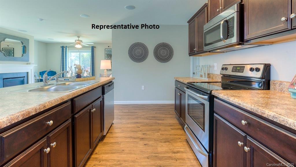 7261 Finnigan Road Charlotte, NC 28215 - Photo 14 of 40 a kitchen with stainless steel appliances granite countertop a sink and a stove