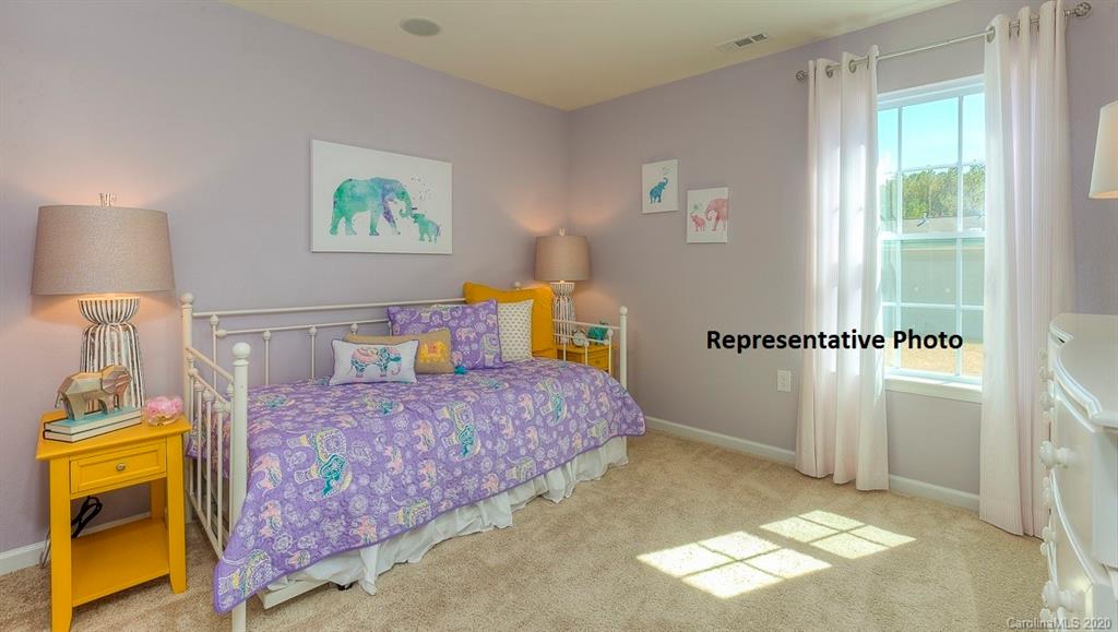 7261 Finnigan Road Charlotte, NC 28215 - Photo 17 of 40 a bedroom with a bed and a painting on the wall