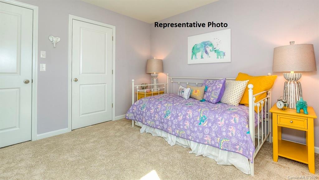 7261 Finnigan Road Charlotte, NC 28215 - Photo 18 of 40 a bedroom with a bed and a lamp