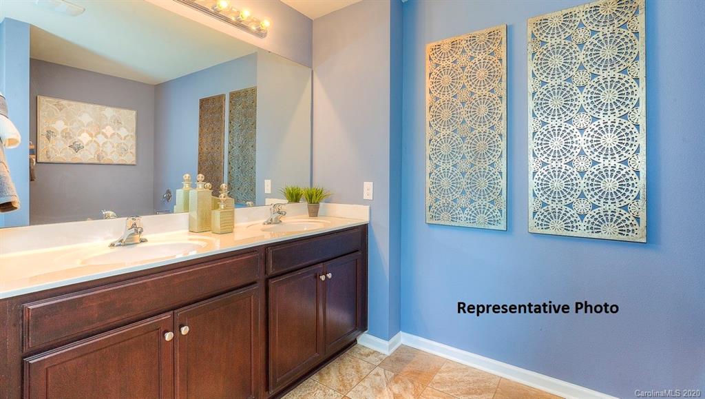 7261 Finnigan Road Charlotte, NC 28215 - Photo 29 of 40 a bathroom with a double vanity sink and a mirror