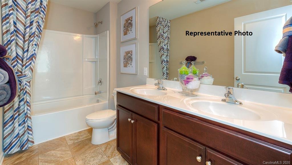 7261 Finnigan Road Charlotte, NC 28215 - Photo 30 of 40 a bathroom with a sink a toilet and a bathtub