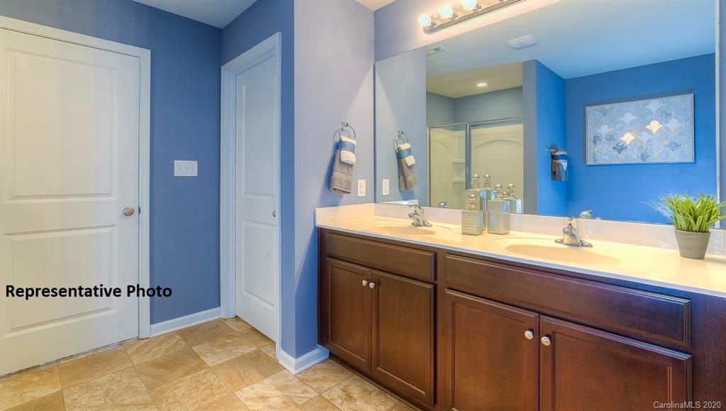 7261 Finnigan Road Charlotte, NC 28215 - Photo 31 of 40 a bathroom with a sink double vanity and a mirror